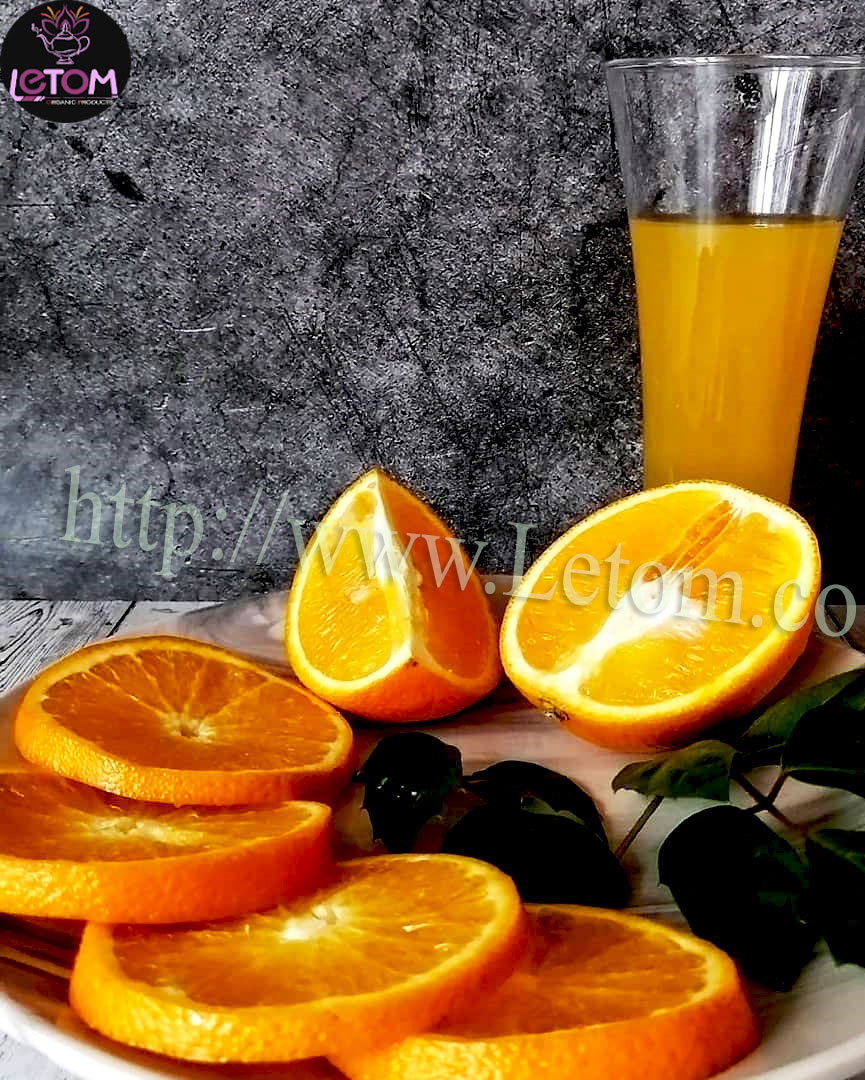 Fresh organic oranges and orange juice on the table