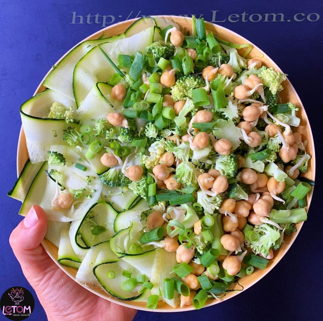 A photo of a plate of vegetables with sprouts of wheat, celery and peas on a plate
