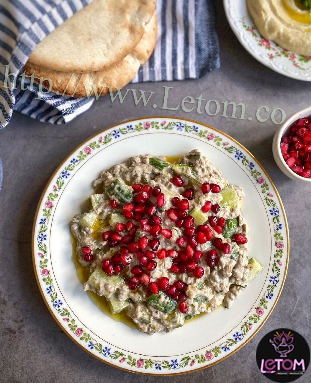 A plate of vegetarian food with pomegranate