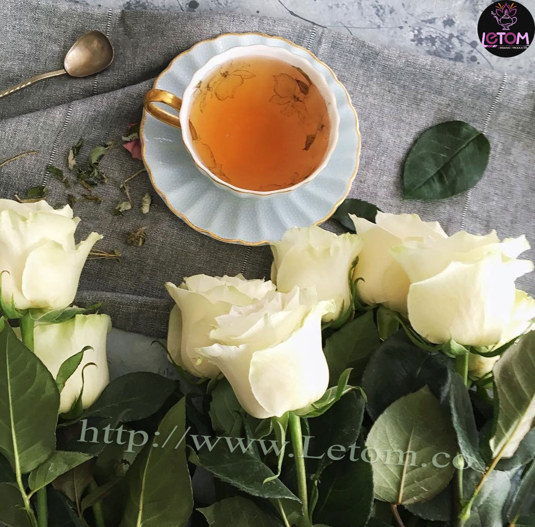 A photo of a cup in Cleansing the body next to a bunch of white roses