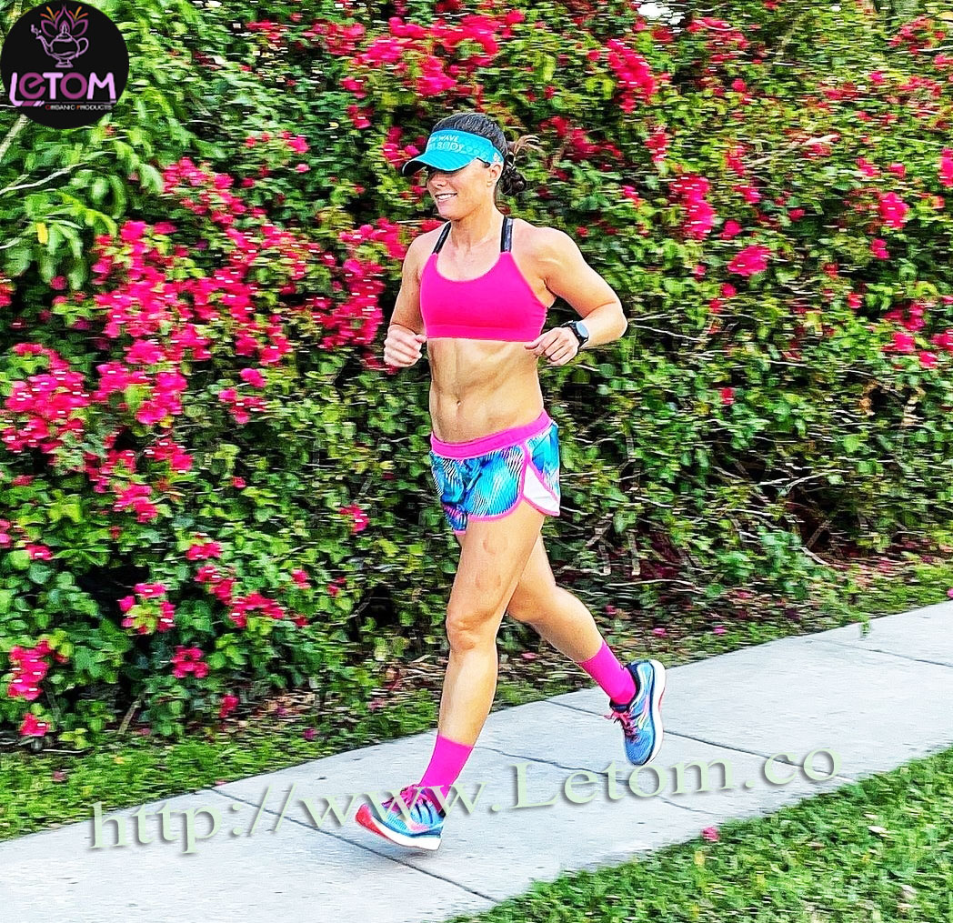 A photo of a woman running in a flat stomach article